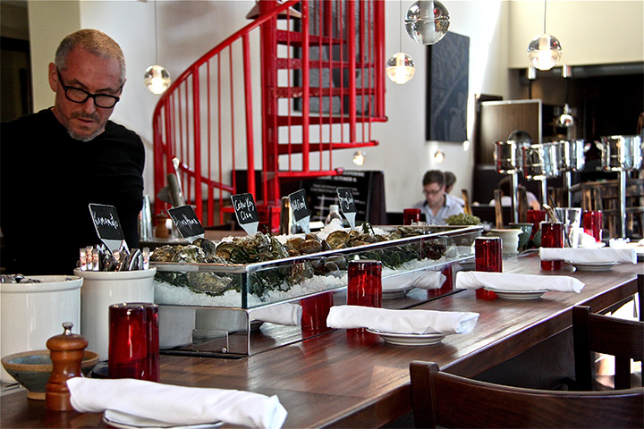 Chef Michael Schwartz beside the oyster display at Michael’s Genuine in Miami’s Design District.