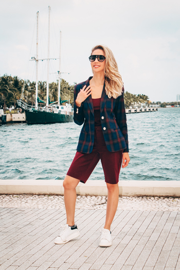 Karen Huggins wearing a checked blazer and Ralph Lauren shorts beside the waterfront