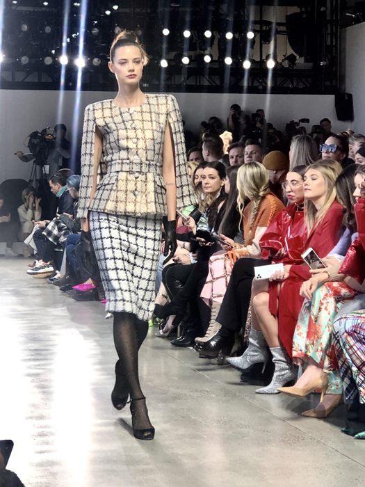 Badgley Mischka model in a checked skirt suit on the Fall 2020 runway