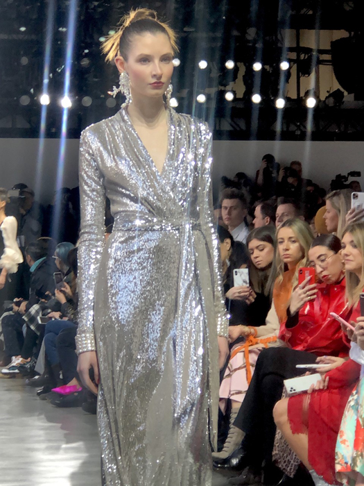 Badgley Mischka model in a shimmering silver belted gown