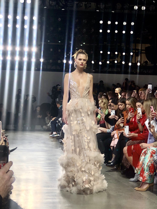 Badgley Mischka model in an embellished pale gown