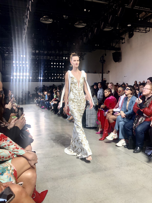 Badgley Mischka model in a metallic trouser suit