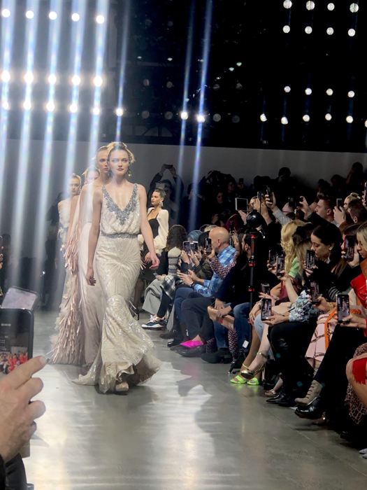 Badgley Mischka model in a pale floor-length gown