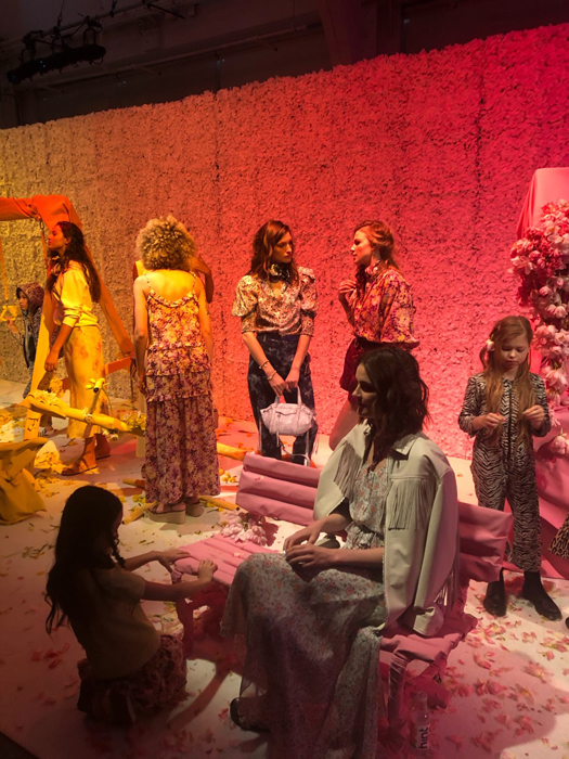 Models at the Rebecca Minkoff presentation in a colorful room