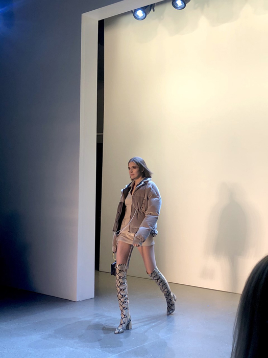 Vivienne Hu Fall 2020 model wearing a pale outfit and patterned knee-high boots