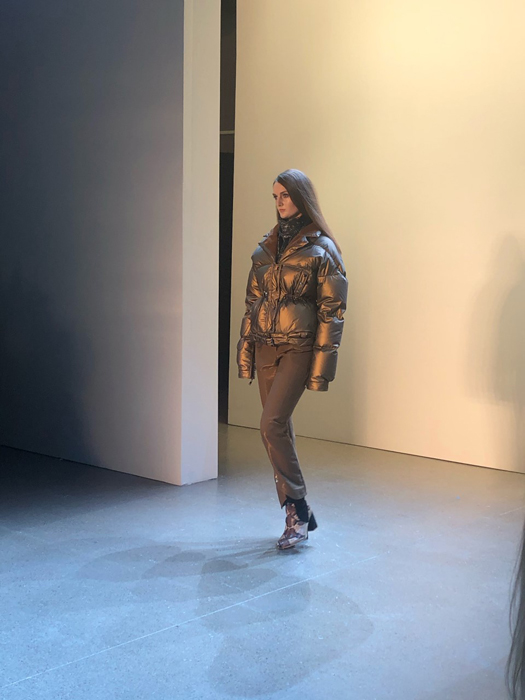 Vivienne Hu model wearing a brown puffer jacket on the runway