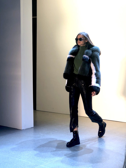 Vivienne Hu model wearing a dark jacket and trousers with sunglasses