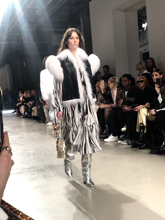 Ingie Paris runway look with white shoulder details and long fringe
