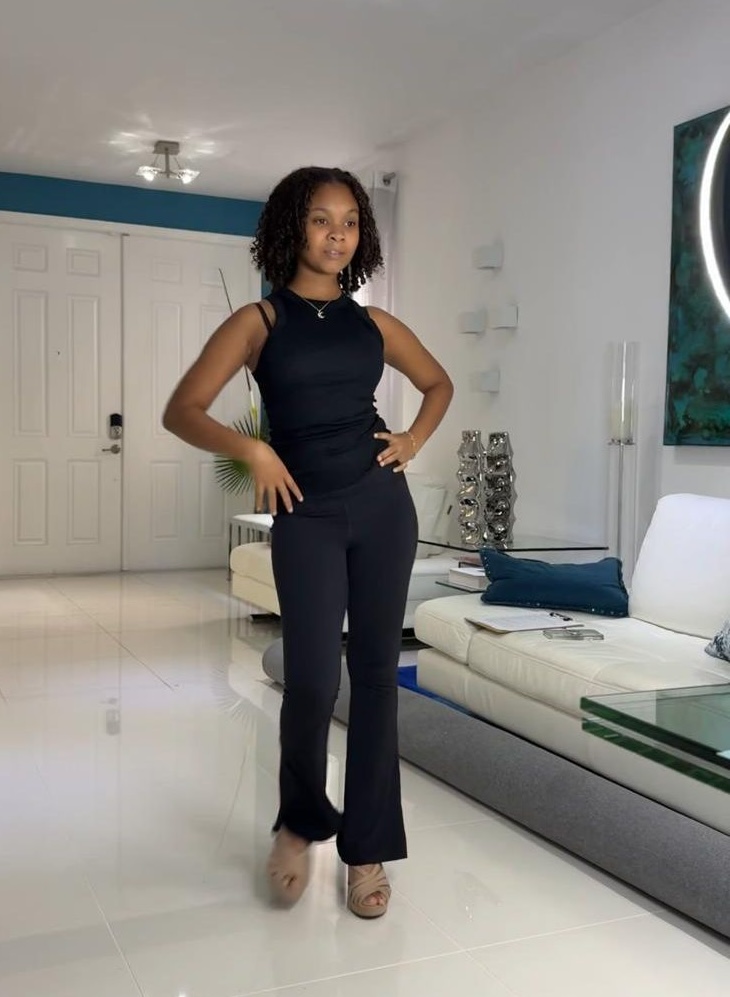 Sophia Rose Hinkson practicing a hands-on-hips pose in a black outfit.