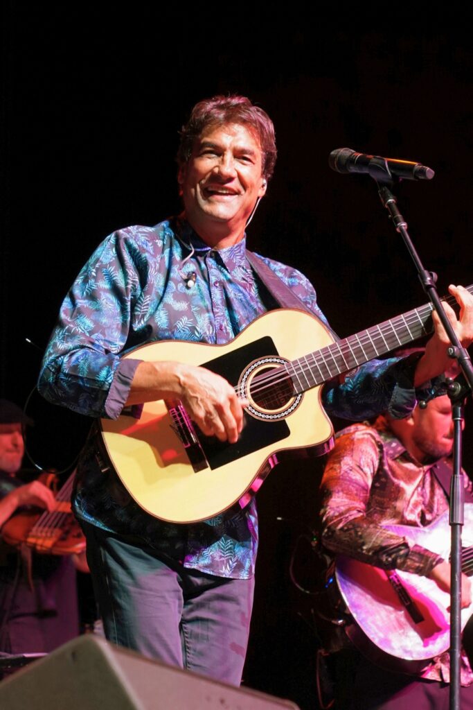 Tonino Baliardo performing guitar on stage