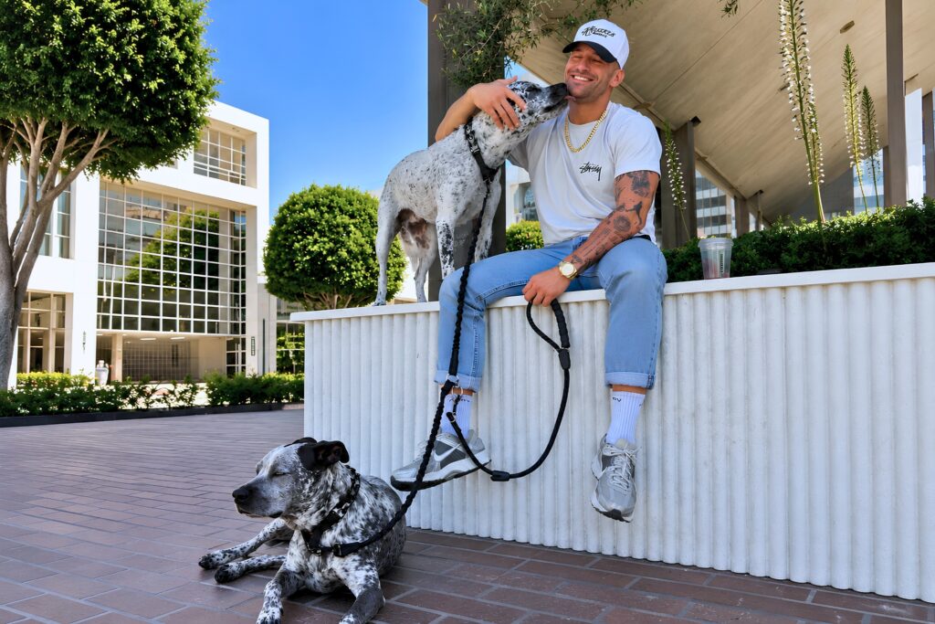 Noah Neiman spending time with his two dogs, reflecting the sense of connection, leadership, and community that inspires The Pack.