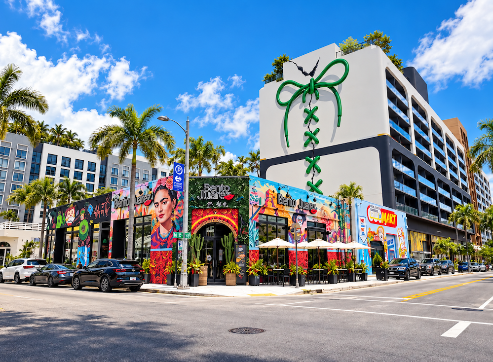 Colorful murals, palm trees and a gift-box mural on a building in Wynwood