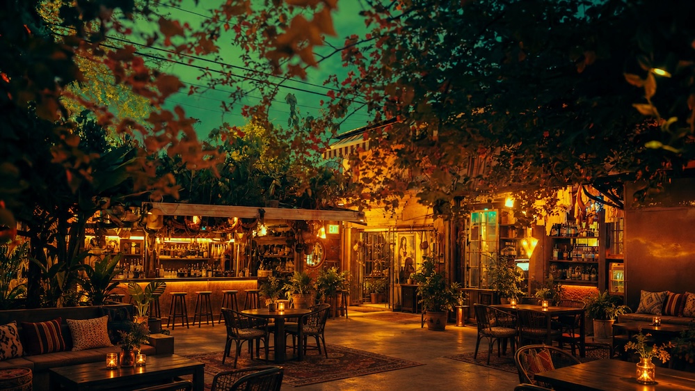 Open-air bar framed by greenery